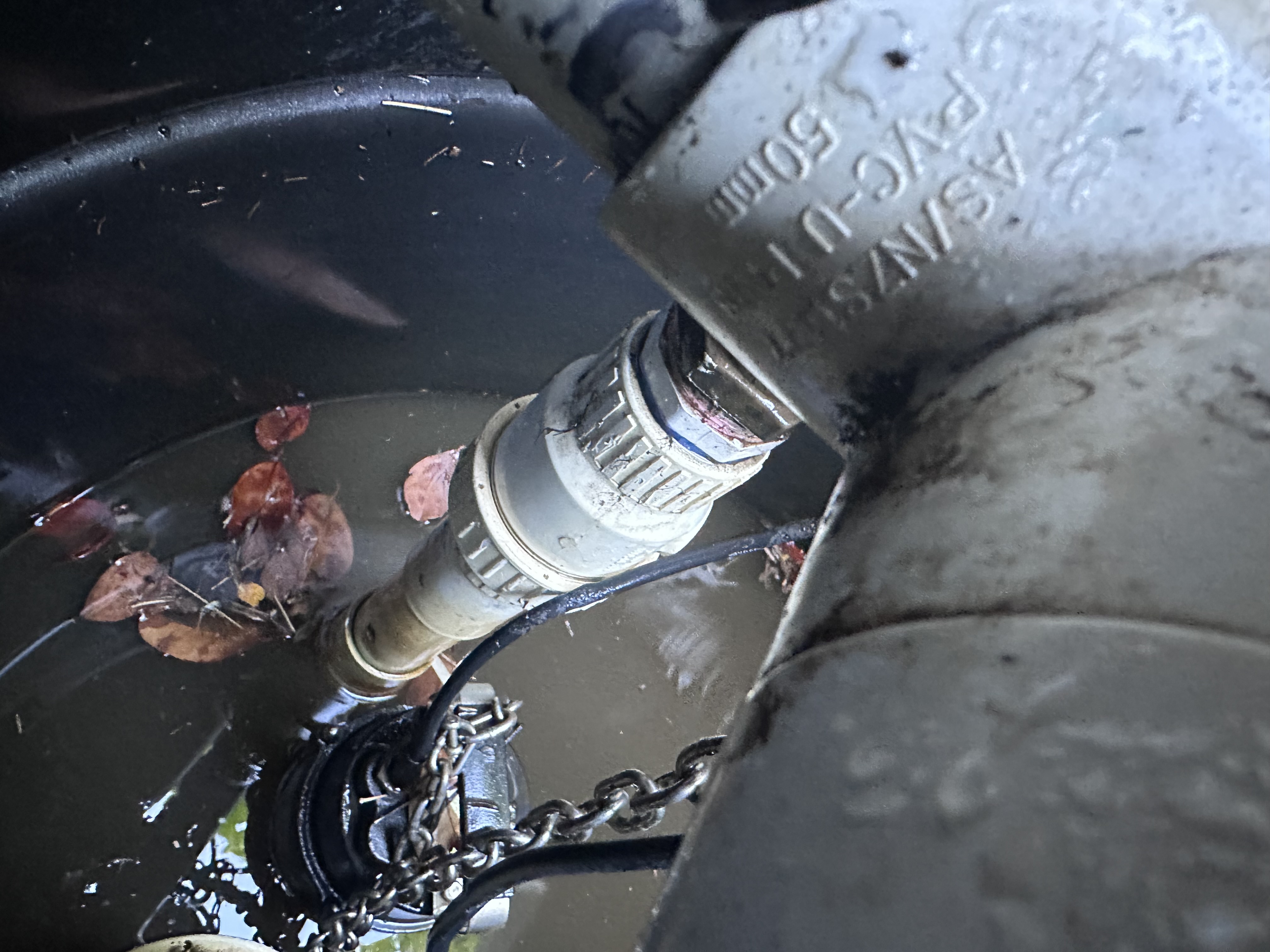 Stormwater sump pit discharge connection and pump hardware inspected on a Fullarton property