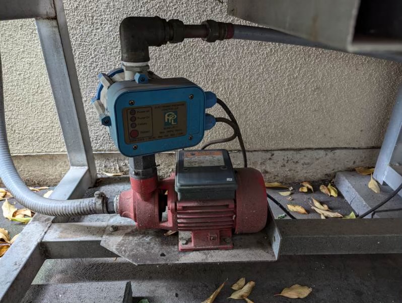 Mayfair plumber installing a residential pressure pump and controller on a heritage property exterior in Norwood, Adelaide