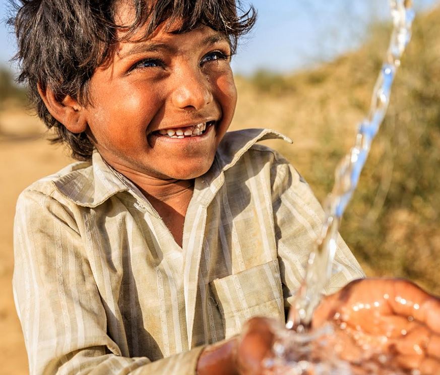 boy washing hands in clean water