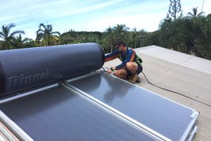 plumber installing a solar hot water system